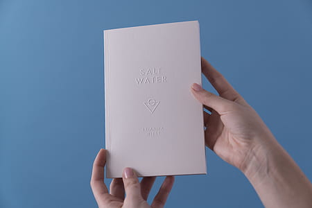 person showin g white paper thumbnail