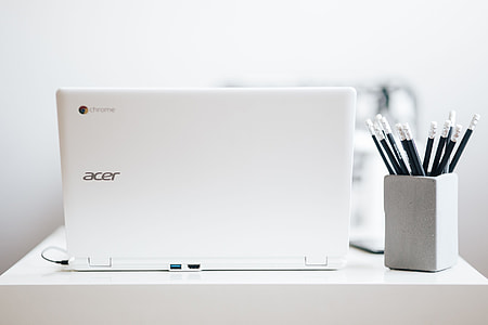 White laptop with smartphone and headphones thumbnail