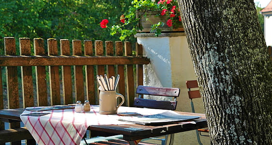 white ceramic pitcher on brown wooden table with chair thumbnail