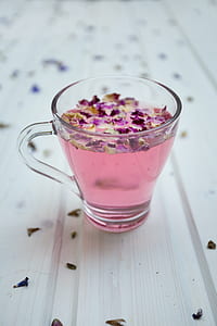clear shot glass filled with pink liquid thumbnail