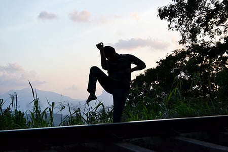 silhouette of person standing near cliff at daytime thumbnail