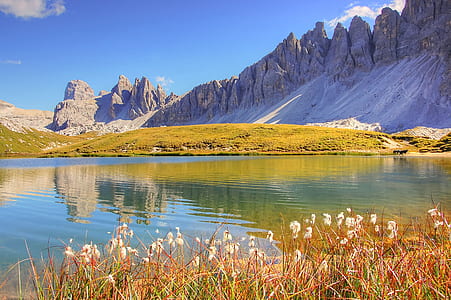 landscape photography of mountains, grass, and lake thumbnail