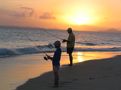 boy and man fishing on the seashore thumbnail