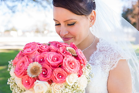woman in wedding dress holding pink and white rose bouquet thumbnail