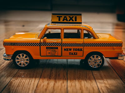 vintage orange taxi sedan die-cast on brown panel thumbnail