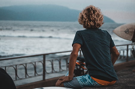 Man Wearing Black Crew-neck T-shirt and Blue Board Shorts thumbnail