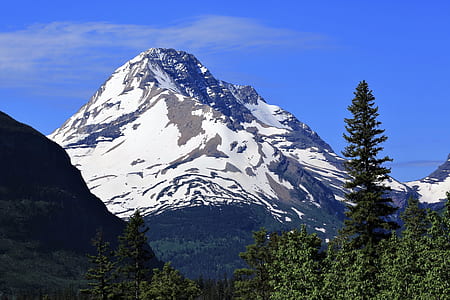 snow covered mountain under blue skies at daytime thumbnail