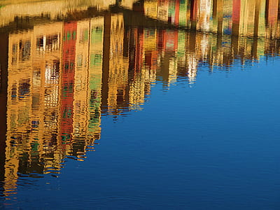 Reflection of High Rise Buildings of Calm Body of Water during Daytime thumbnail