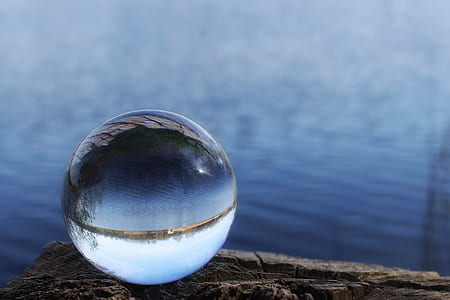 round clear ball on brown surface thumbnail