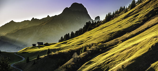green and black high mountain under blue sky at daytime thumbnail
