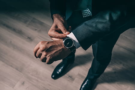 Man Fixes Shirt Cuff Photo thumbnail