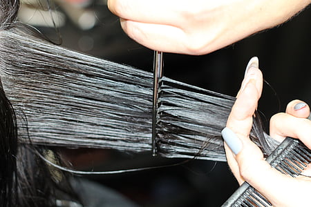 person combing hair with black hair comb thumbnail