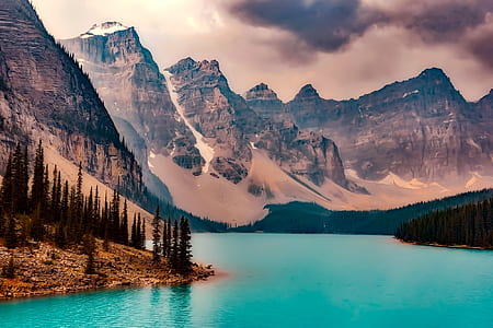 body of water surrounded by brown and gray mountains thumbnail