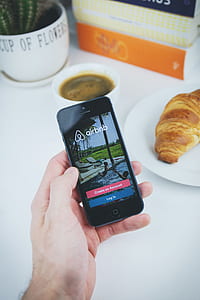 person using smartphone that displays lock screen thumbnail