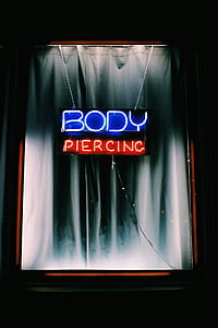 Body Piercing neon signage with glass thumbnail