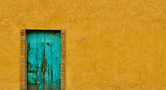 building with teal wooden door thumbnail
