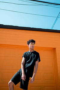 man wearing black crew-neck T-shirt and black shorts thumbnail