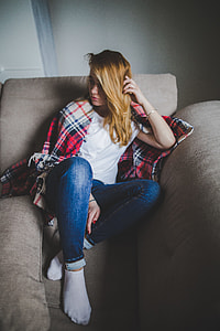 woman sitting on brown fabric sofa thumbnail