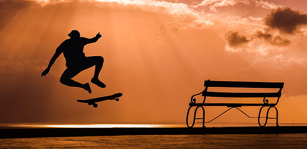 silhouette of person playing skateboard during golden hour thumbnail