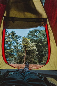 person lying inside tent during day time thumbnail