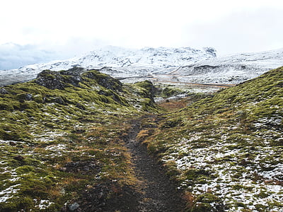 green rock formation front of ice-capped mountain at daytime thumbnail