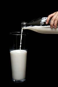 person pouring milk on high ball glass thumbnail
