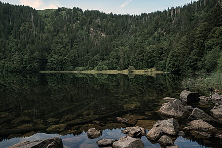reflection of mountain on body of water thumbnail