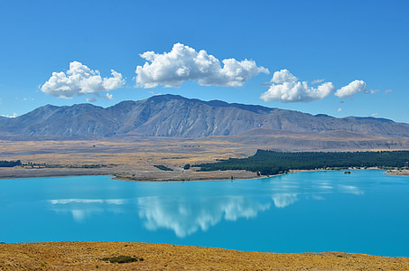 lake and mountain horizon during day time thumbnail