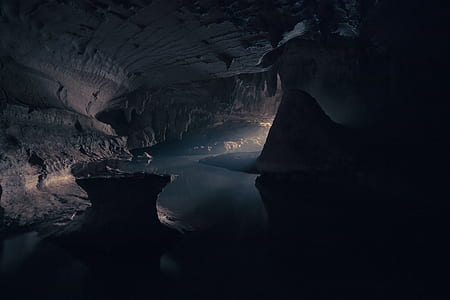 cave near body of water thumbnail