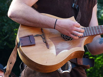 man playing brown guitar thumbnail