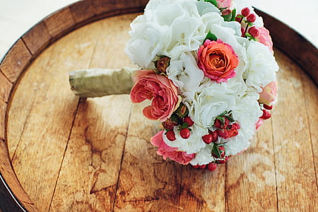 white and red petaled bouquet of flower on brown wooden tray thumbnail