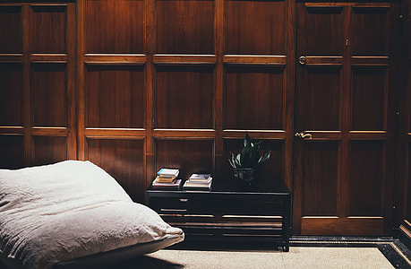 black wooden side table near white mattress in roomk thumbnail