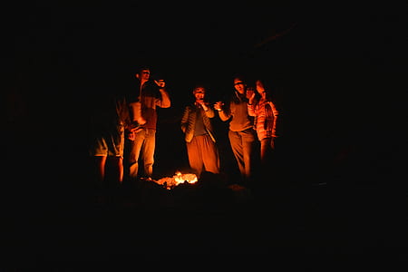people standing in front of bonfire thumbnail