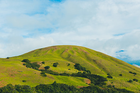 green mountain under white clouds at daytime thumbnail