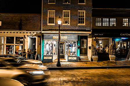 cars on road in front of concrete building night time thumbnail