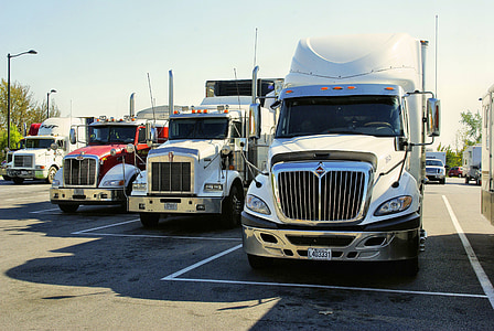 four semi trailer trucks thumbnail