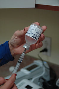 person holding syringe and vial thumbnail