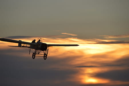 flying biplane during golden hour thumbnail