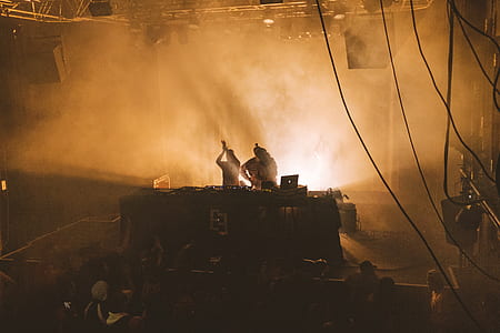 silhouette of two person standing on stage thumbnail