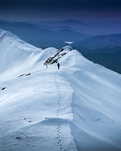 person walking on top of the mountain during daytime thumbnail