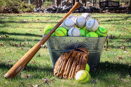 baseball lot on bucket beside baseball bat and gloves thumbnail