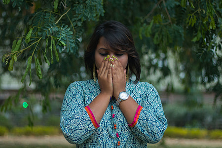 woman standing under green tree thumbnail