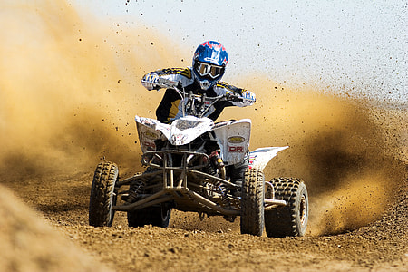 person riding black and white ATV at daytime thumbnail