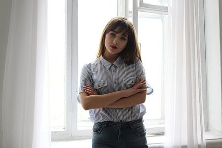 woman wearing white and black pinstriped western shirt near white wall thumbnail