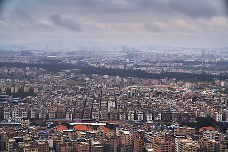 aerial view of city under cloudy sky during daytime thumbnail