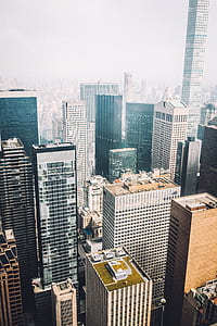 aerial photography of concrete high-rise buildings under cloudy sky thumbnail