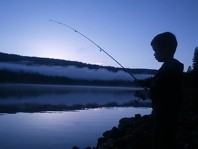 boy fishing on body of water thumbnail