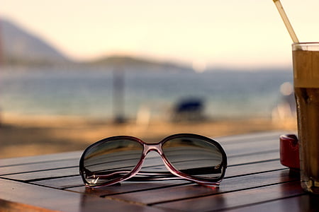 selective focus photography of aviator-style sunglasses on wooden table thumbnail
