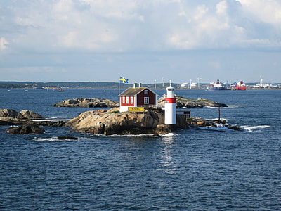 white lighthouse near the house thumbnail