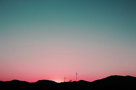silhouette of a mountain during orange sunset thumbnail